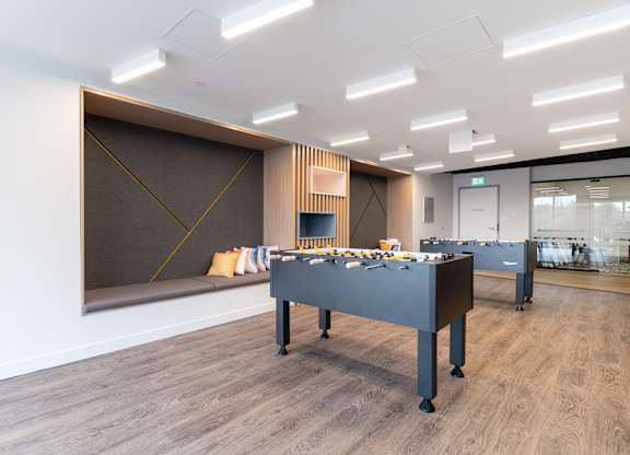 A room with a long table and chairs.