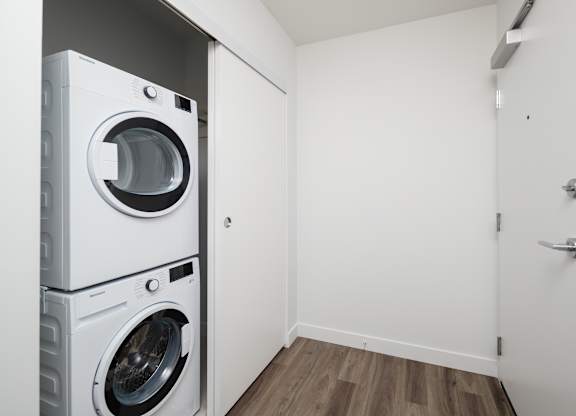 A white washing machine and dryer in a small laundry room.