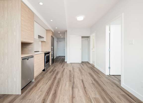 A kitchen with wooden floors and white walls.