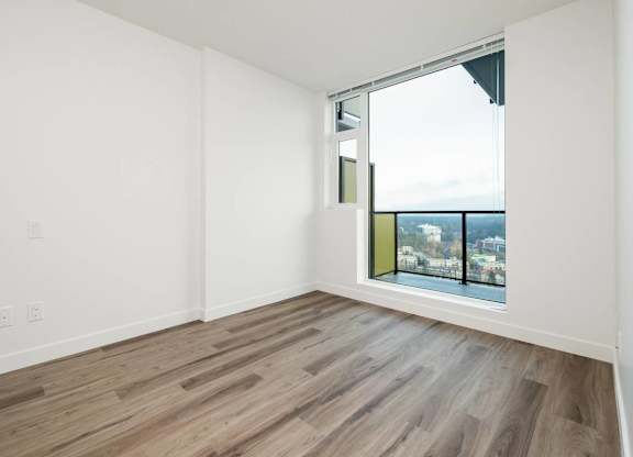A room with a window overlooking a cityscape.