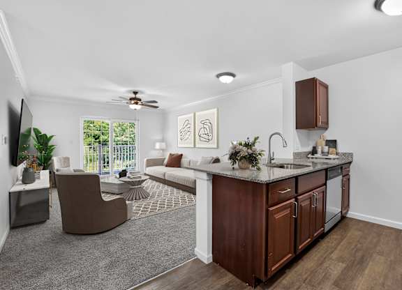 A modern kitchen with dark wood cabinets and a white countertop.