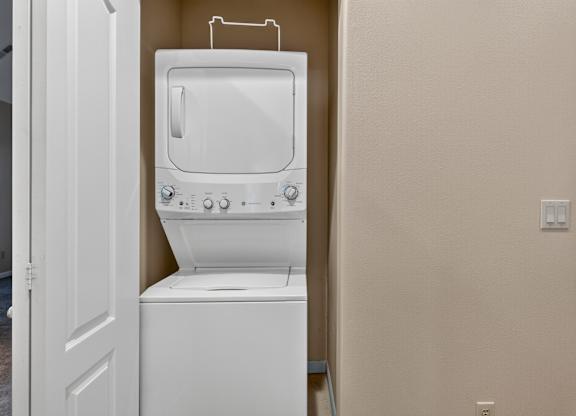 A white toilet with a tank and a white door is in a room.