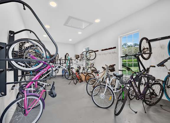 A bike rack full of bicycles in a room.