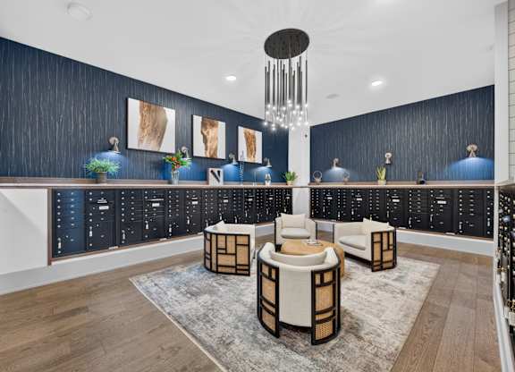 A modern living room with a dark blue accent wall and a white ceiling.