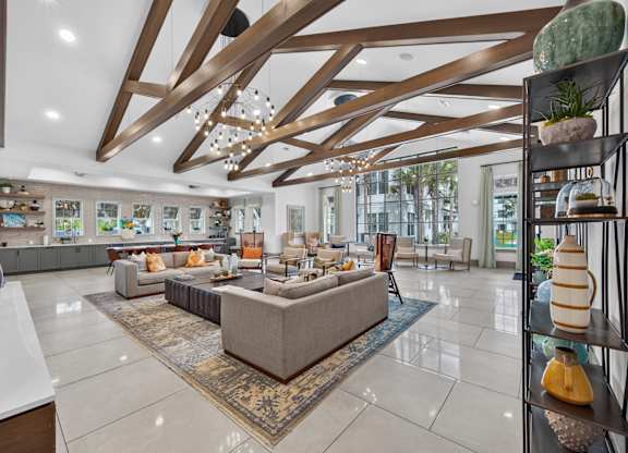 A spacious living room with a large sectional sofa and a rug in the center.