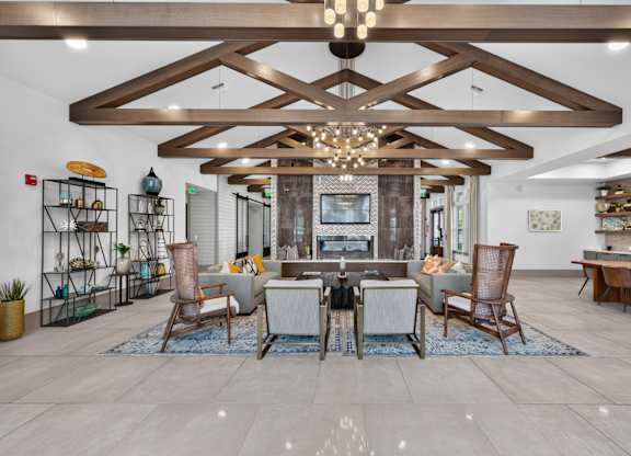A modern living room with a wooden ceiling and a large sectional sofa.