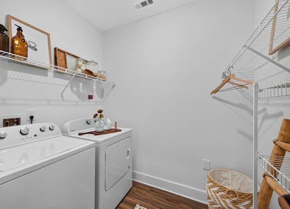 A white laundry room with a washer and dryer.