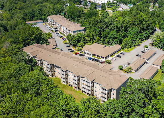 An aerial view of a residential complex surrounded by trees.