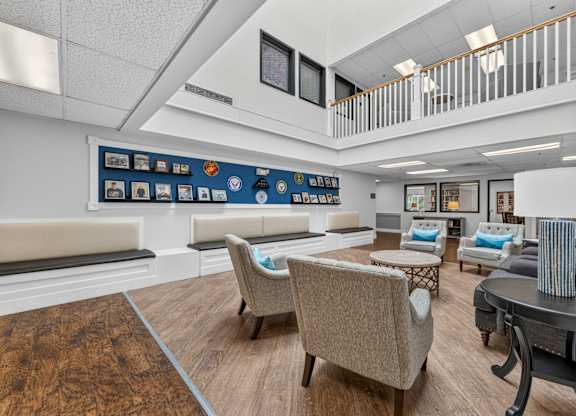 A living room with a couch, chairs, and a coffee table.