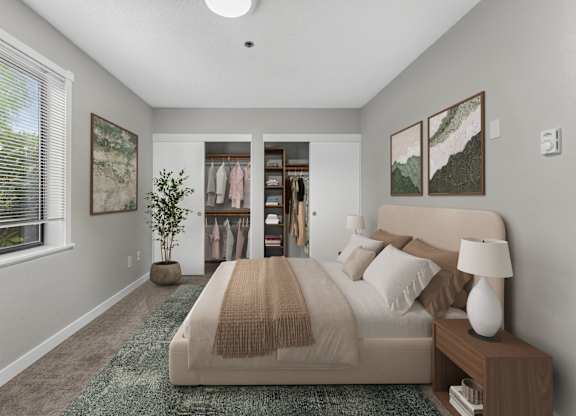 A bedroom with a large bed and a window with blinds.