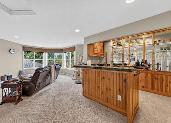 A living room with a couch, a coffee table, and a bar area.