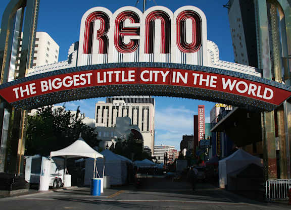 A sign that says Reno in red and white with a blue bar underneath it.