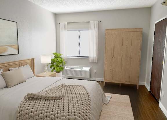 A bedroom with a large bed and a window with blinds.
