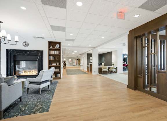 A spacious living room with a fireplace and a variety of seating options.