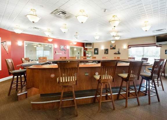 A restaurant with wooden chairs and tables.