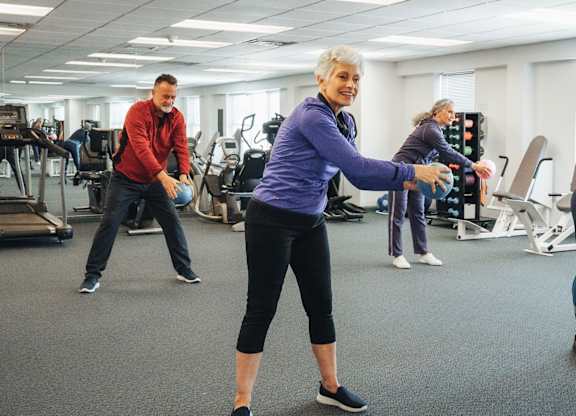 A group of people exercising in a gym.