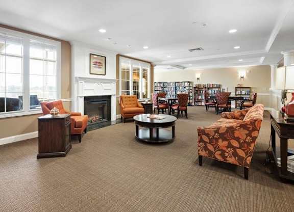A living room with a fireplace and a bookshelf.