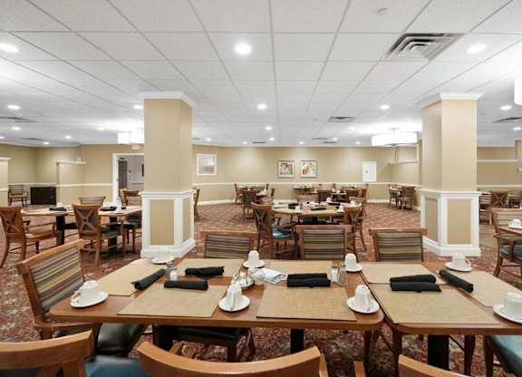 A restaurant with tables and chairs set up for dining.