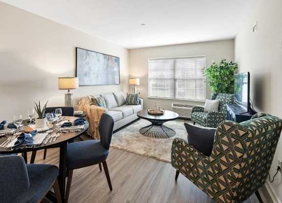 A modern dining room with a round table set for a meal.