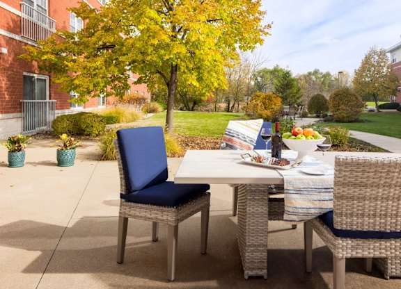 A table with chairs and a menu is set up outside.