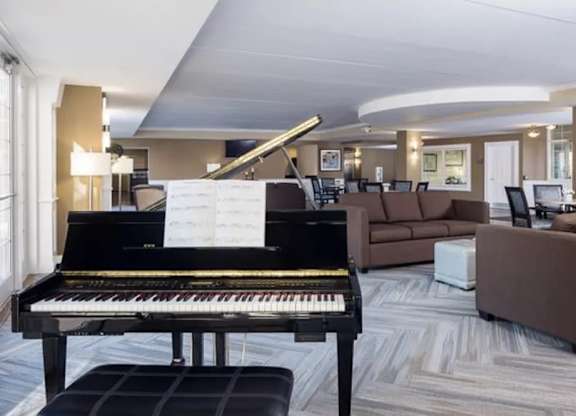 A grand piano is in the middle of a living room.