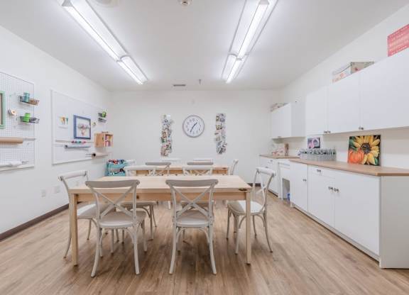Community kitchen with dining table and chairs at Schuyler Commons Apartments, Utica, 13502