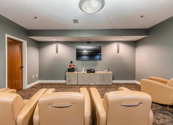 Home theater room with reclining chairs at Schuyler Commons Apartments, Utica, NY 13502