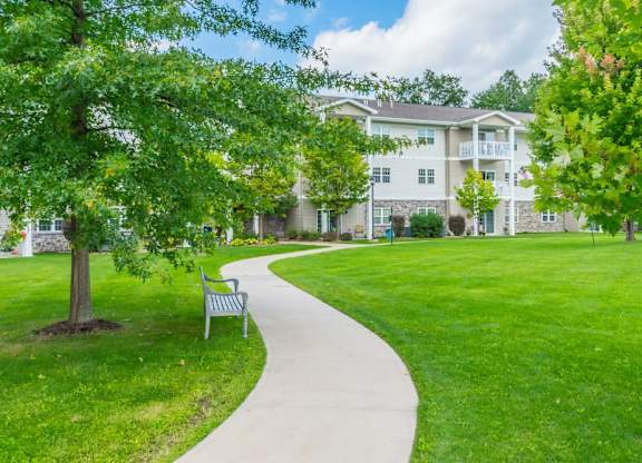 Curved walkway through landscaped courtyard at Schuyler Commons Apartments, Utica, NY