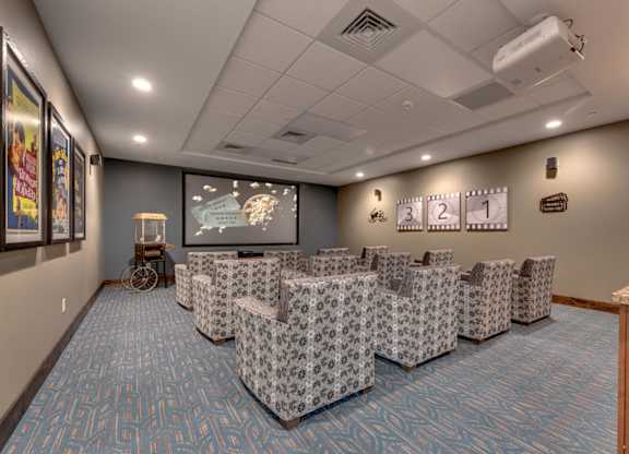 Theater room with stadium seating and projector at Mountain Lakes Estates Apartments, Reno, Nevada