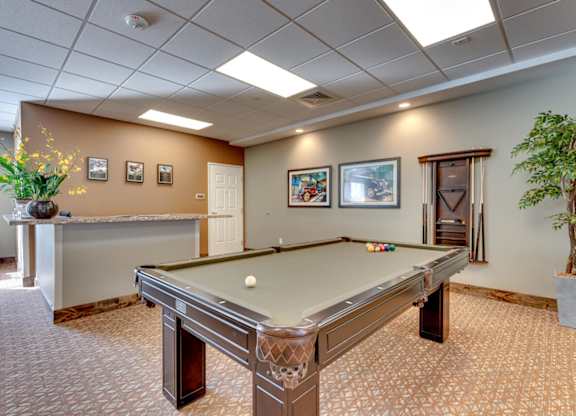 Recreation room with pool table and cue rack at Mountain Lakes Estates Apartments, Nevada