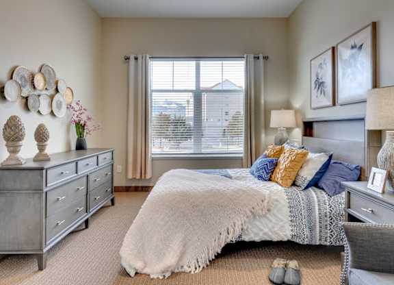 Bedroom with gray furniture and decorative wall art at Mountain Lakes Estates Apartments, Reno, 89521