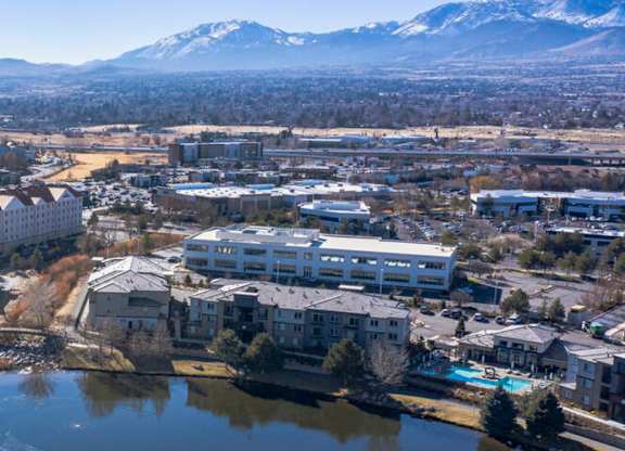 Aerial view of residential buildings with snow capped mountains at Mountain Lakes Estates Apartments, Reno, NV