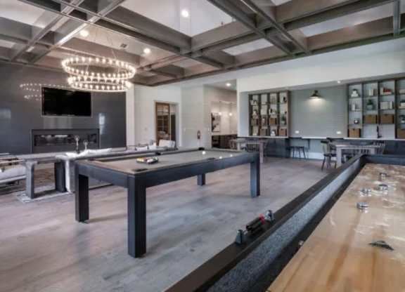 A billiard table with the number 1 on it is in the foreground of this image. at Atwater at Nocatee Apartments, Florida, 32081