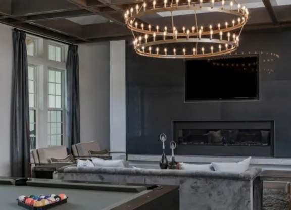 A modern living room with a fireplace and a television. at Atwater at Nocatee Apartments, Florida, 32081
