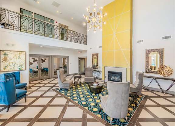 A large, open living room with a fireplace and a chandelier. at The Spring at Silverton Apartments, Fort Worth, 76133