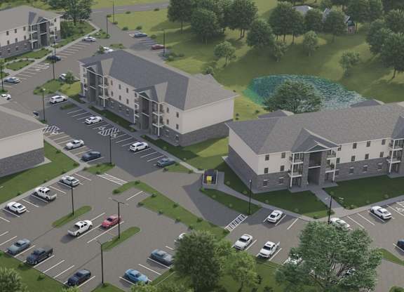 A rendering of a residential complex with a parking lot in front.