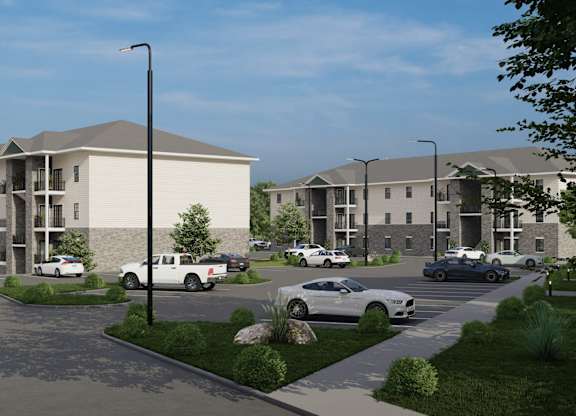 A rendering of a modern apartment complex with cars parked in the driveway.