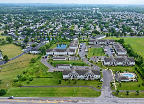 A bird's eye view of a residential area with houses and a road.