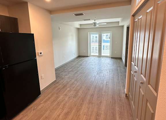 A room with a black desk and a window.