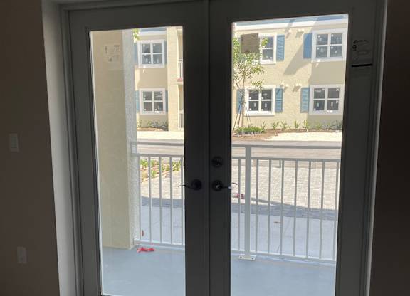 A window with a view of a building across the street.
