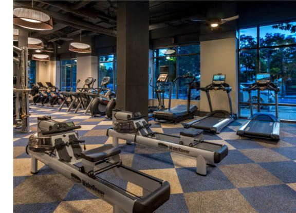 a gym with cardio equipment and a view of the pool  at Shearwood Station, New Rochelle, NY, 10801