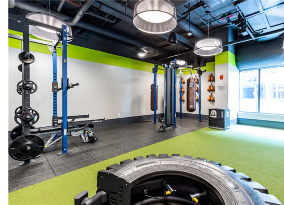 a large tire in a gym with green flooring and a white wall with a window  at Shearwood Station, New Rochelle, New York