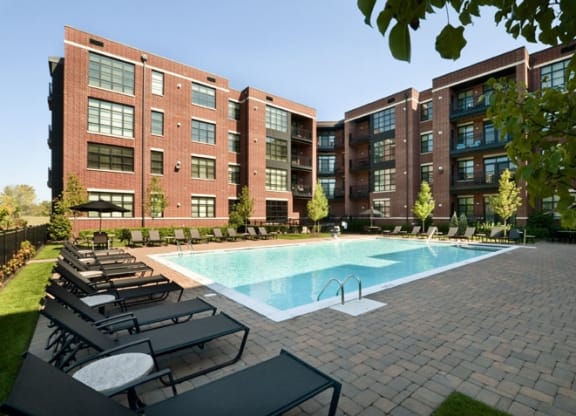 Swimming pool and lounge area at the Sheffield at Englewood Apartments in Englewood, NJ