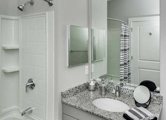 A bathroom with a white tub and sink.