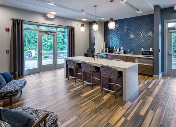 A modern kitchen with a bar area and a dining table.