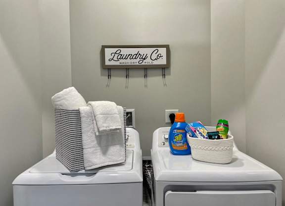 Laundry Co. sign above washer and dryer.