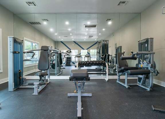 A spacious gym with various exercise equipment.