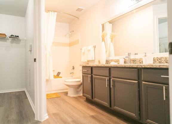 A bathroom with a toilet, sink, and shower.