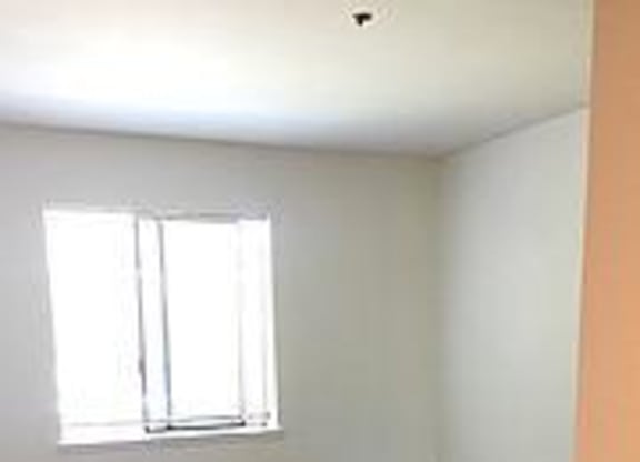 Bedroom with wooden floor at Redwood Landing Apartments, California