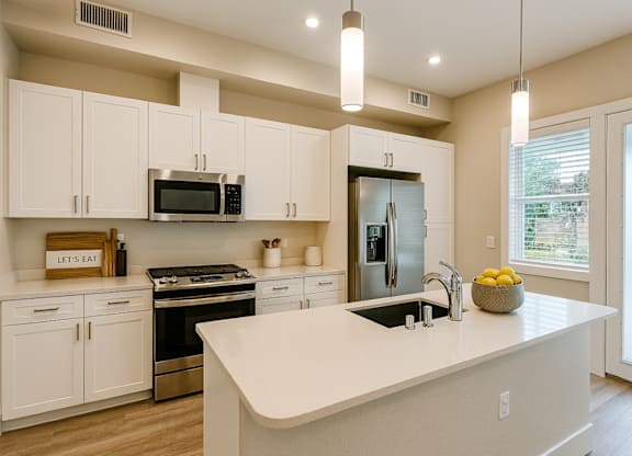 A kitchen with white cabinets and a large island.at Edgeway Plaza, Rohnert Park, 94928